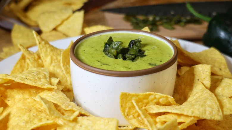 Three-ingredient queso dip with poblano peppers served in white ramekin
