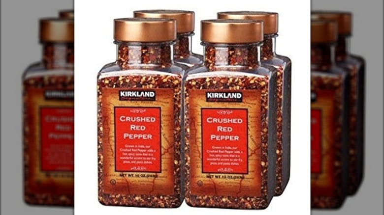 four bottles of crushed red pepper grouped together