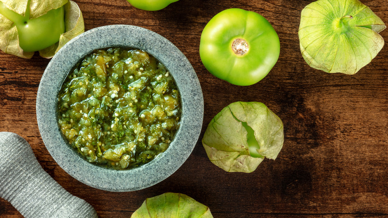 Salsa verde surrounded by tomatillos