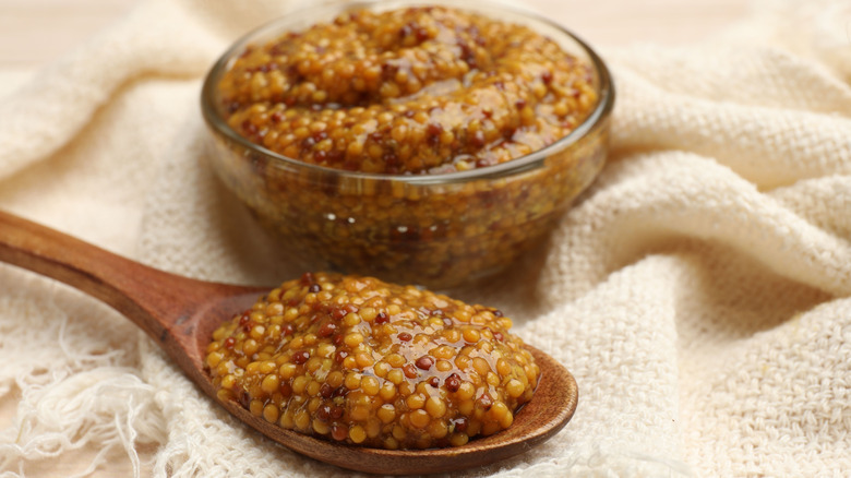 A bowl and spoon of whole-grain mustard