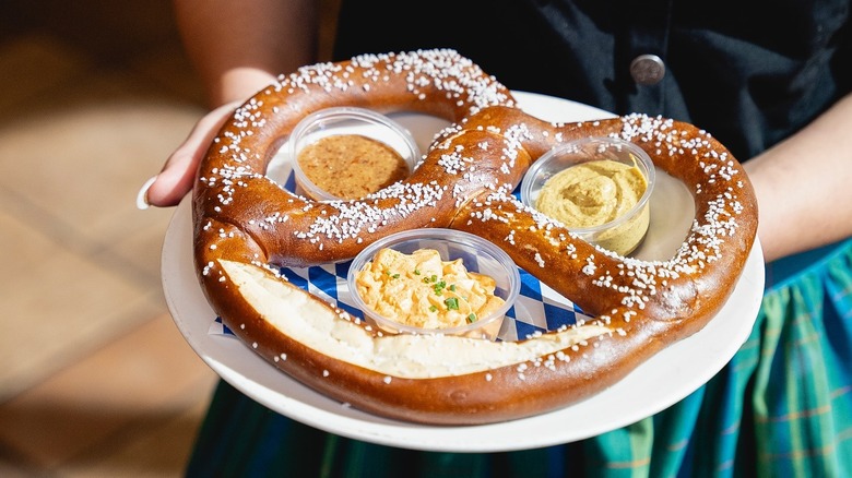 A person holding a giant pretzel at Hofbräuhaus in Las Vegas