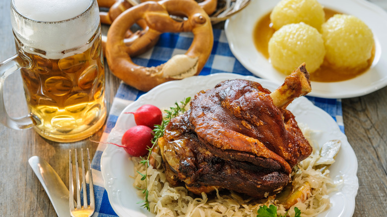 A variety of German dishes and beer on a table at a restaurant