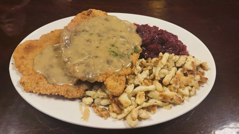 A plate of schnitzel with spaetzle and red cabbage at Laschet's Inn