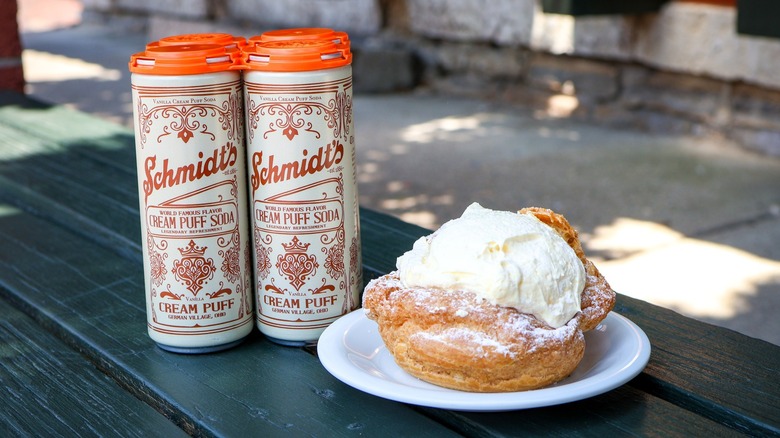 A cream puff next to cans of Schmidt's soda at Schmidt's Sausage Haus und Restaurant