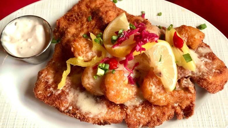 A plate of schnitzel with shrimp and lemon at The Bavarian Chef