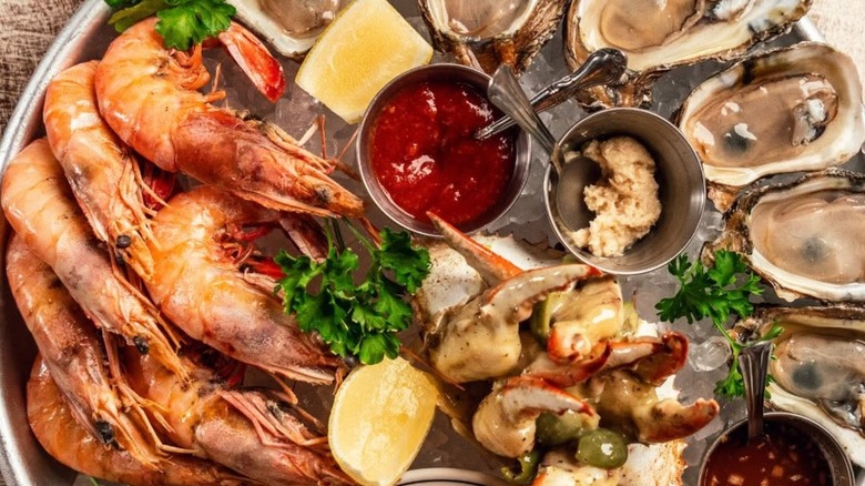 Platter with assorted seafood and dips including crawfish and oysters