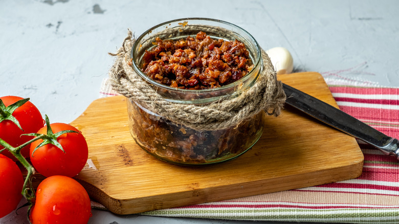 jar of bacon jam on cutting board