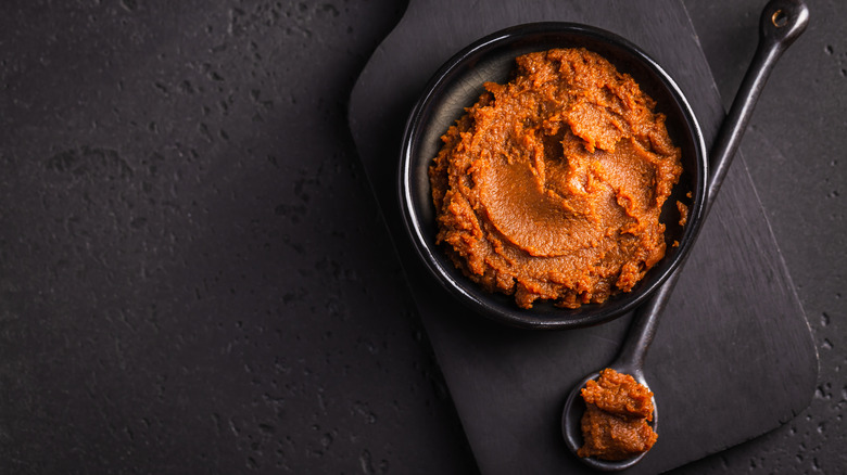bowl and spoonful of red miso paste