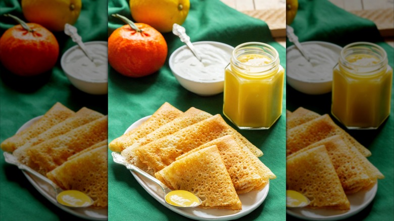 Crêpes on plate with lemon curd jar