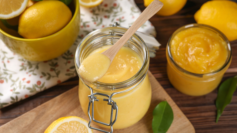 Lemon curd in a jar with a spoon
