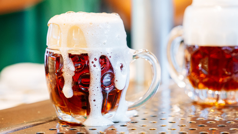 German beer mugs full of amber-colored Diesel drinks with lots of foam