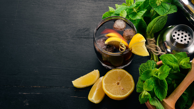 Lemon and mint bourbon smash with bartending tools