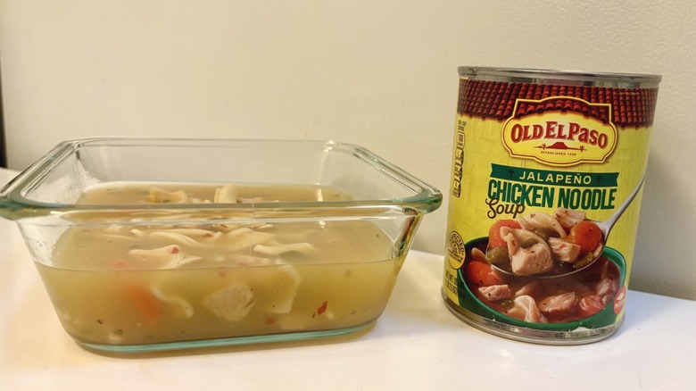 A can of Old El Paso Jalapeño Chicken Noodle Soup next to a square dish of prepared soup
