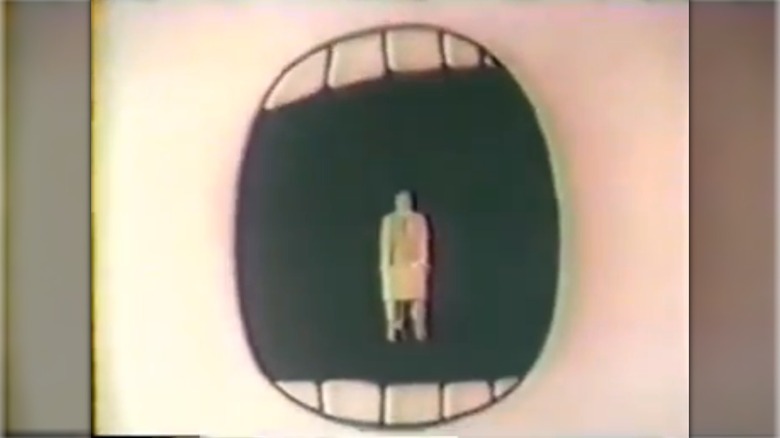 Still from commercial showing a spokesperson gradually being swallowed up by a cartoon mouth