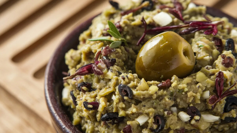 Close-up of a bowl of black and green olive tapenade