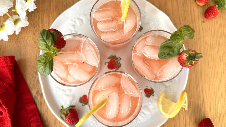 four roasted strawberry and basil lemonades on a serving tray