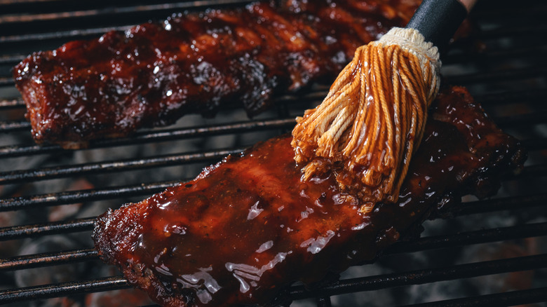 Barbecue sauce with ribs on grill