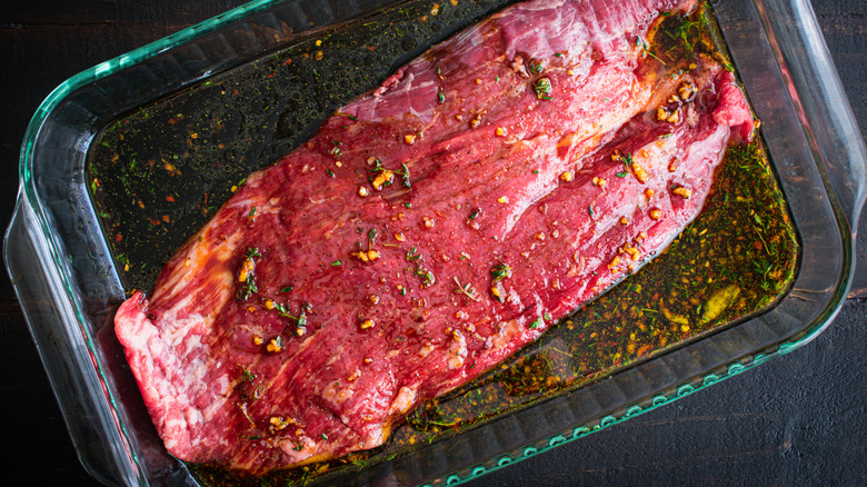 Steak marinating in a dish
