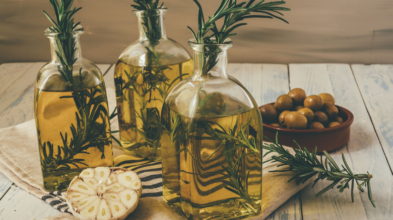Oil being infused with herbs on countertop