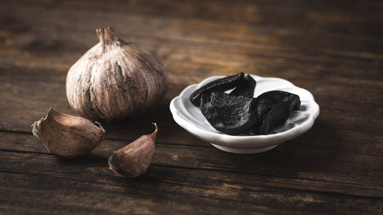 Black garlic with tray of cloves