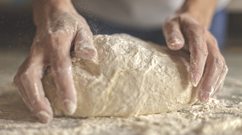 Hands kneading dough