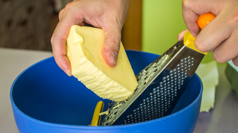Grating frozen butter into a bowl