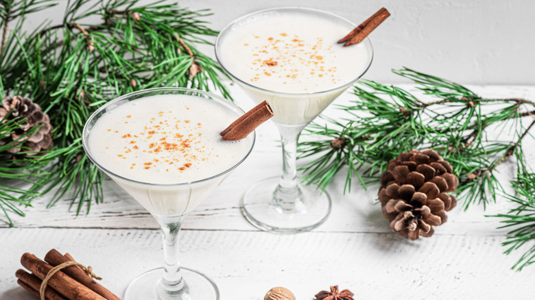 Two Brandy Alexanders with cinnamon sticks