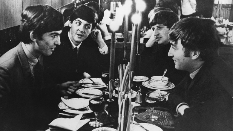 The Beatles eating a chatting in a restaurant