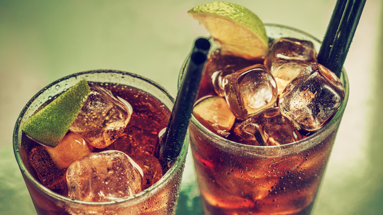 Rum and Coke cocktail with a slice of lime