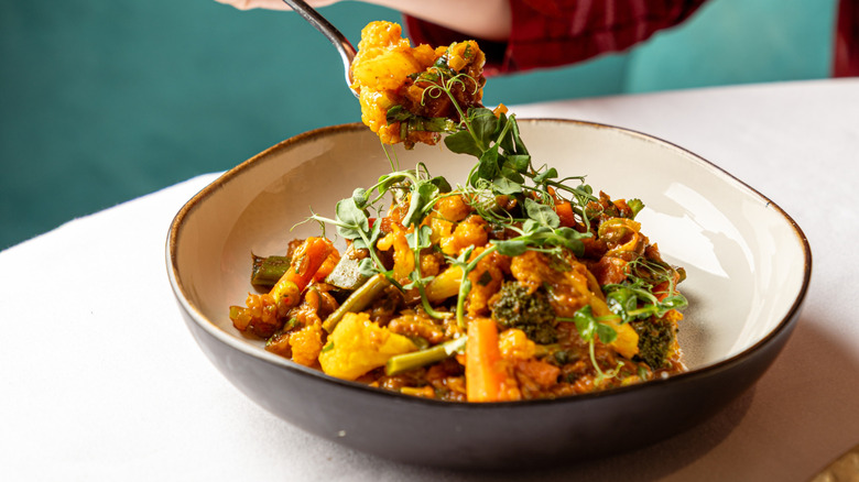 Bowl and fork full of cauliflower and veggies
