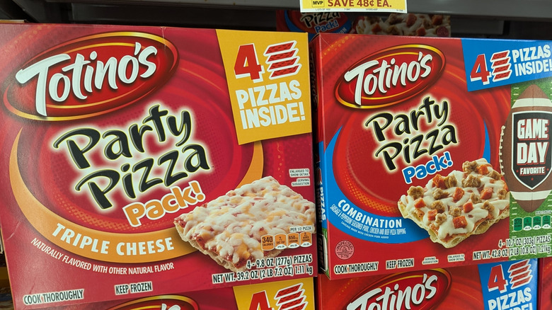two Totino's Party Pizzas sitting on a grocery store shelf