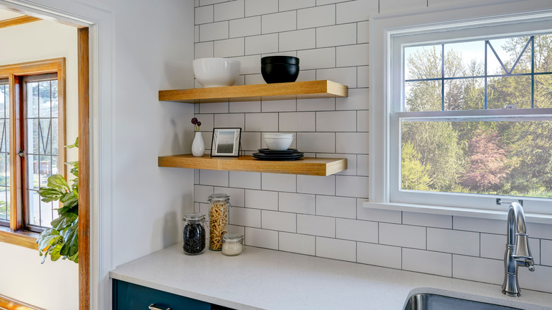 Floating shelves with tile above sink
