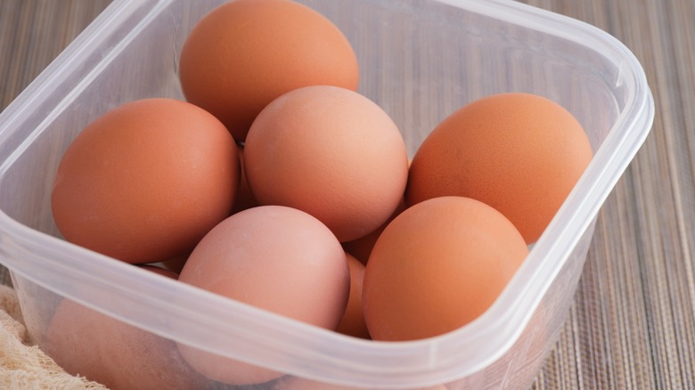 Hard-boiled eggs in plastic container