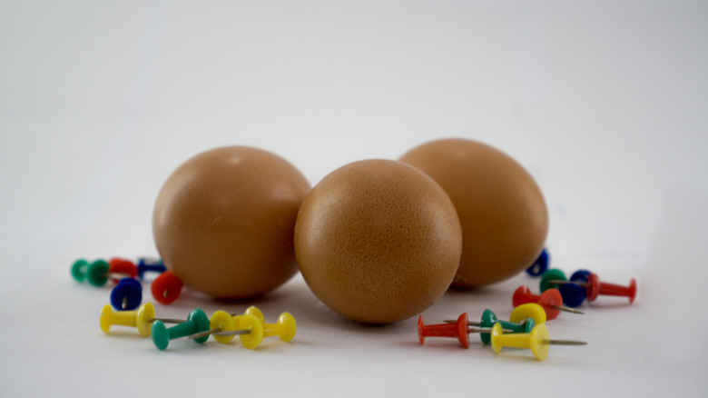 Eggs and thumbtacks