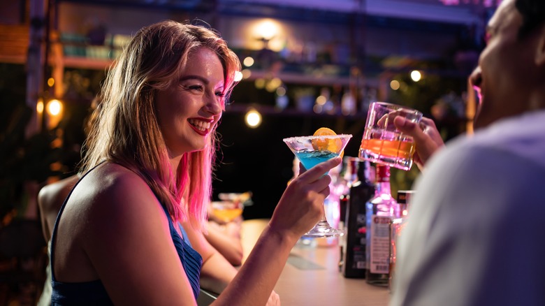 Man and woman enjoying drinks at a bar