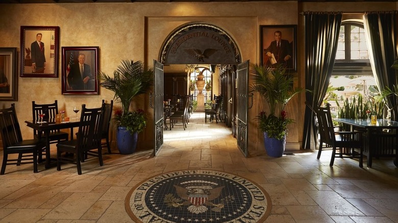 Interior of the Presidential Lounge, including seal mosaic and portraits