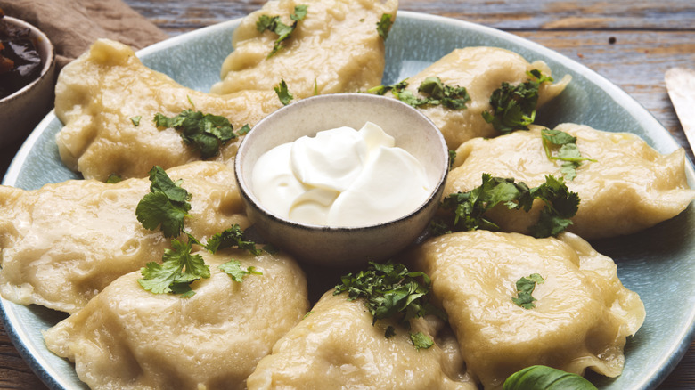 Plate of pierogies with sour cream