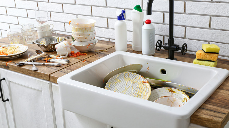 Piles of dirty dishes in sink and on counter