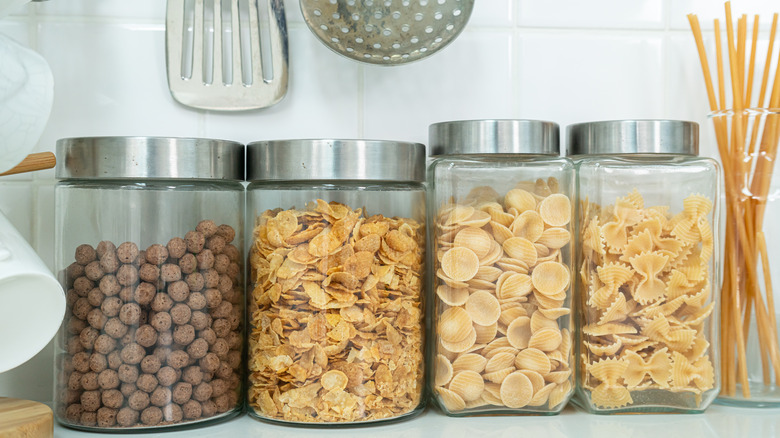 Canisters of pasta and cereal on kitchen counter