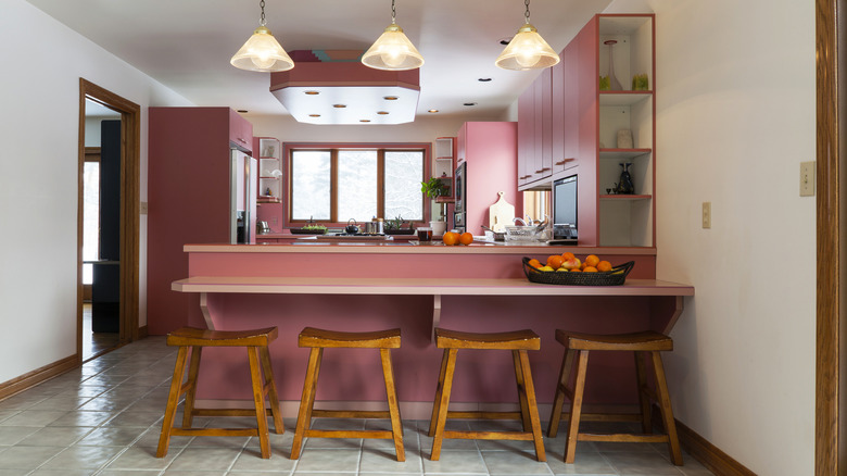 Two-tier kitchen island in pink kitchen