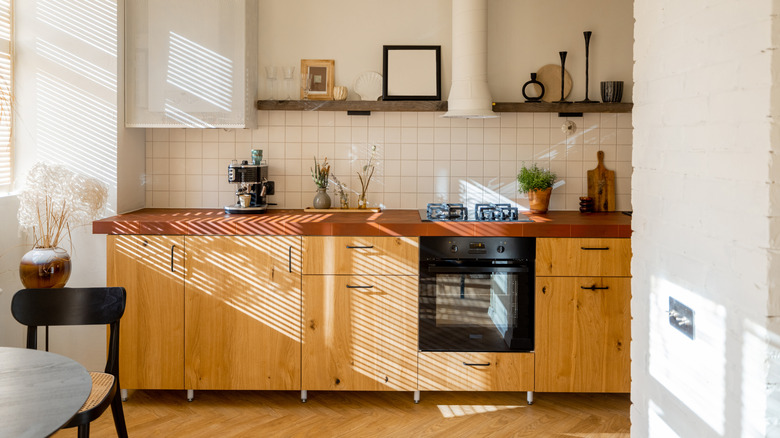 Sunlit kitchen with wood slab front cabinets