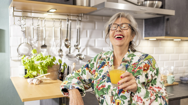 woman laughing in kitchen with cabinet lights