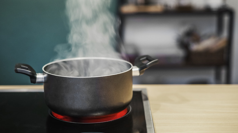dark corner of kitchen with pot boiling