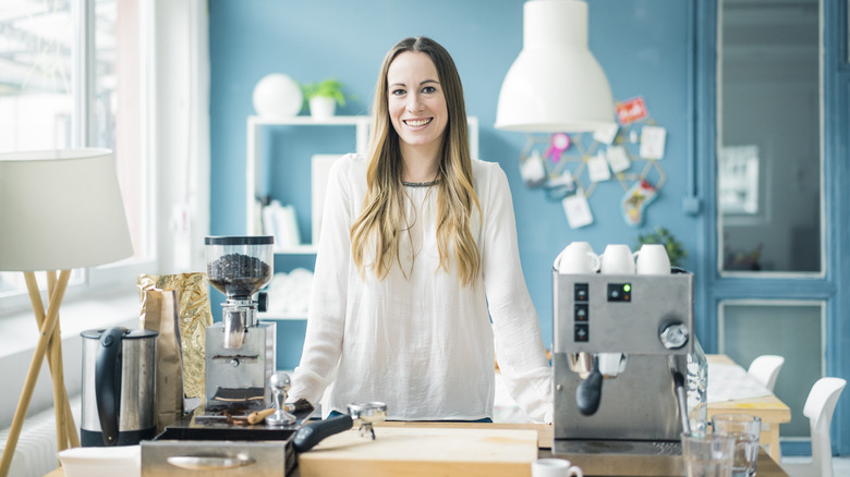 woman standing in bright turquoise kitchen