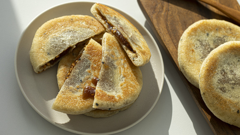A plate of sliced and whole hotteok