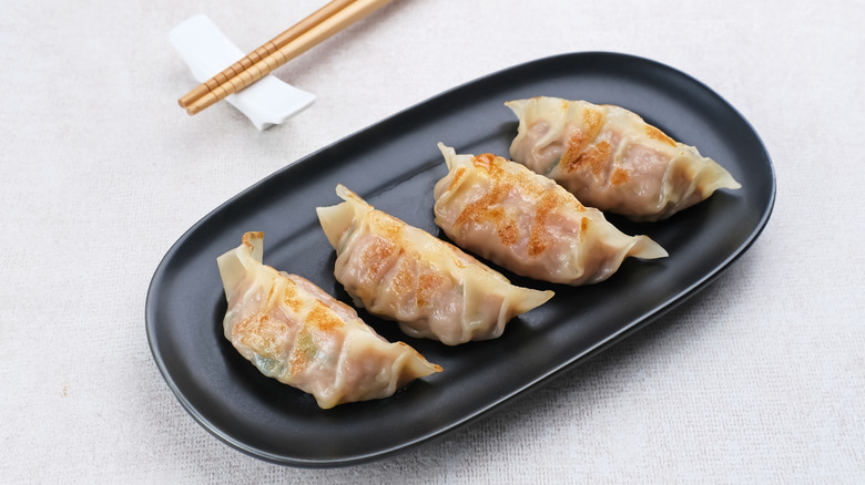 A plate of mandu with chopsticks
