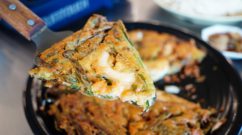 A sliced piece of pajeon on a spatula