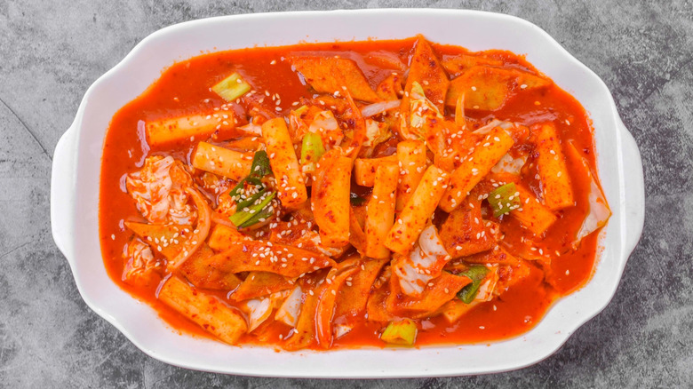 A plate of tteokbokki on a marble background