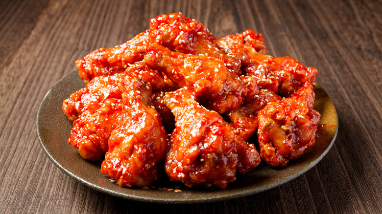 A plate of yangnyeom chicken garnished with sesame seeds