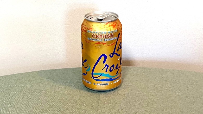 Orange La Croix in a can sitting on a table